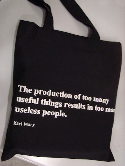 black fabric bag whith white text on it quoted by karl marx 