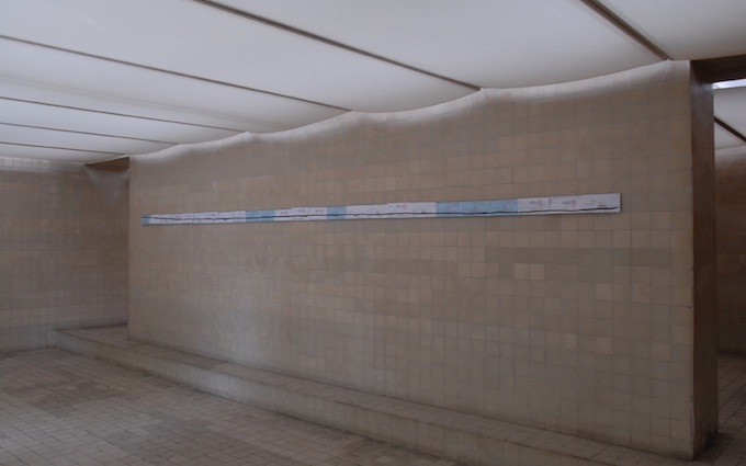 a straight line with folded letters on a wall